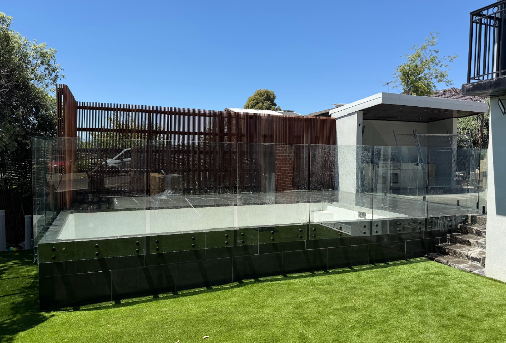 Glass pool fencing with timber slat wall