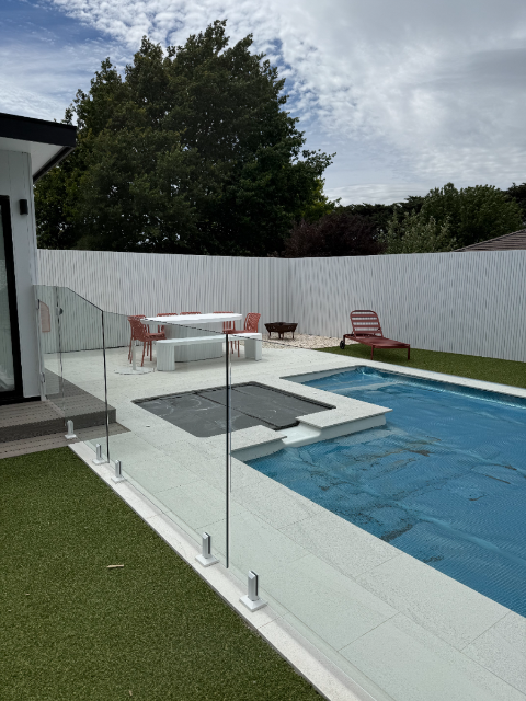 Glass pool fencing with outdoor furniture