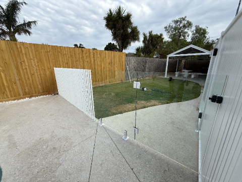 Glass pool fencing, timber fence, palm trees