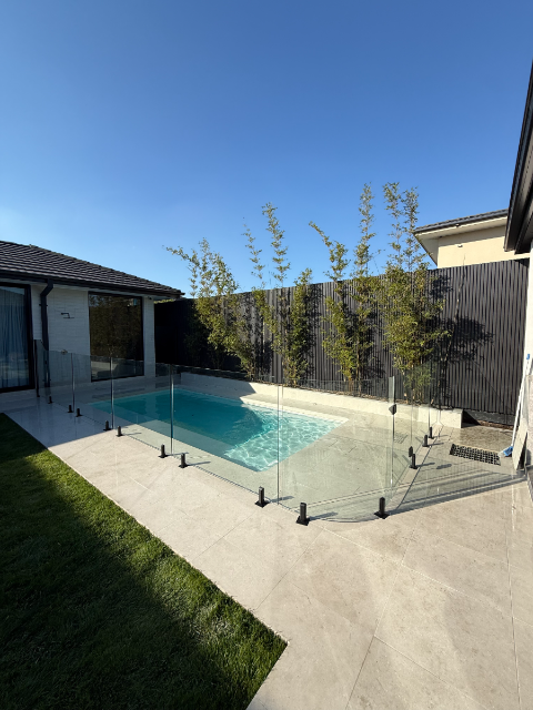 Glass fencing with dark timber slat wall