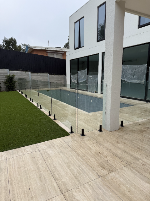 Modern home with glass pool fencing