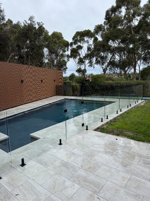 Pool with glass fencing and timber cladding